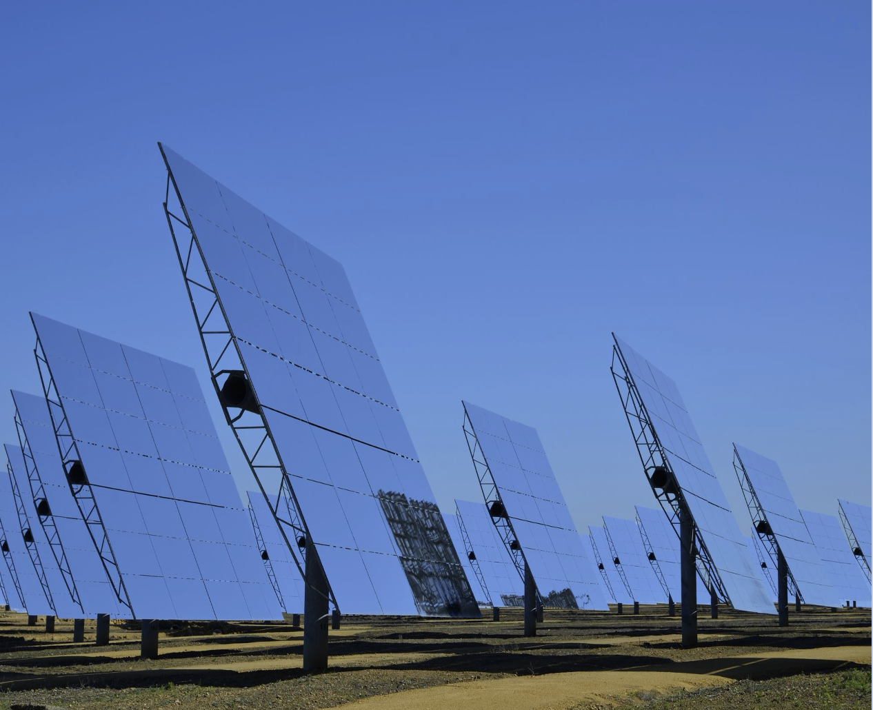 Solar concentrator panels against a clear blue sky